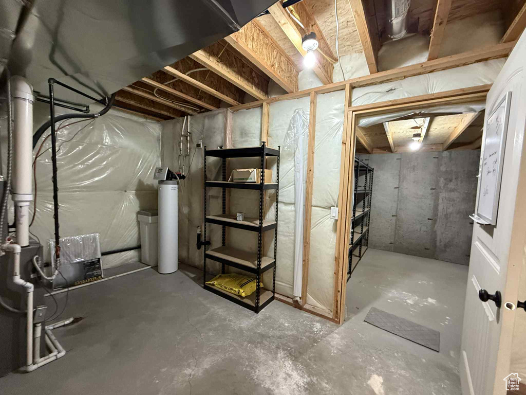 Unfinished below grade area featuring a water softener