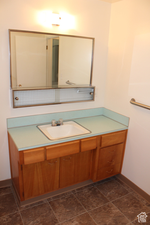 Bathroom featuring vanity and baseboards