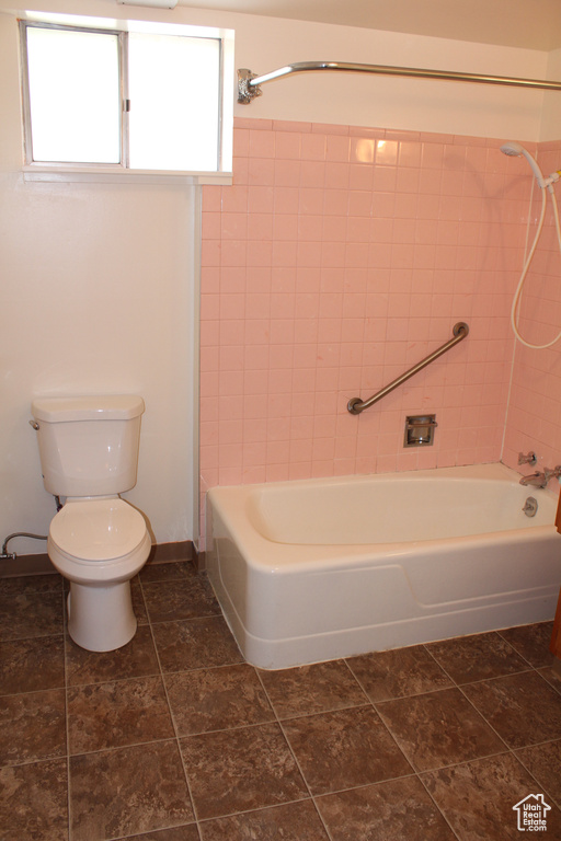 Full bathroom featuring toilet and shower / washtub combination