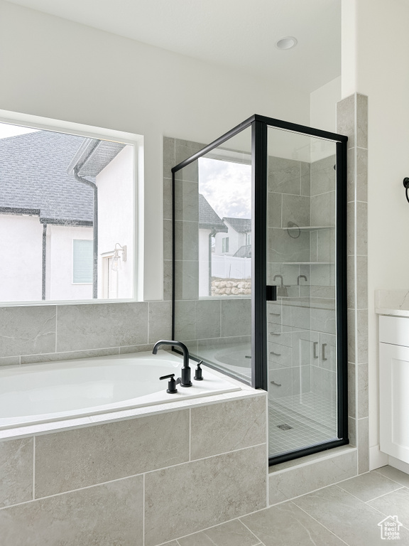 Bathroom with a bath, a stall shower, and tile patterned floors