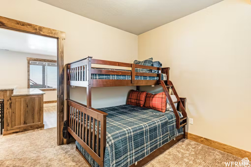Bedroom with baseboards and carpet floors
