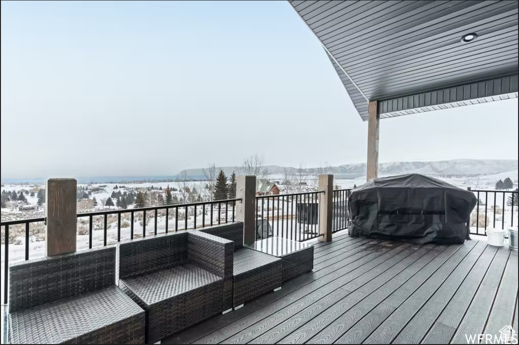 Snow covered deck with an outdoor hangout area