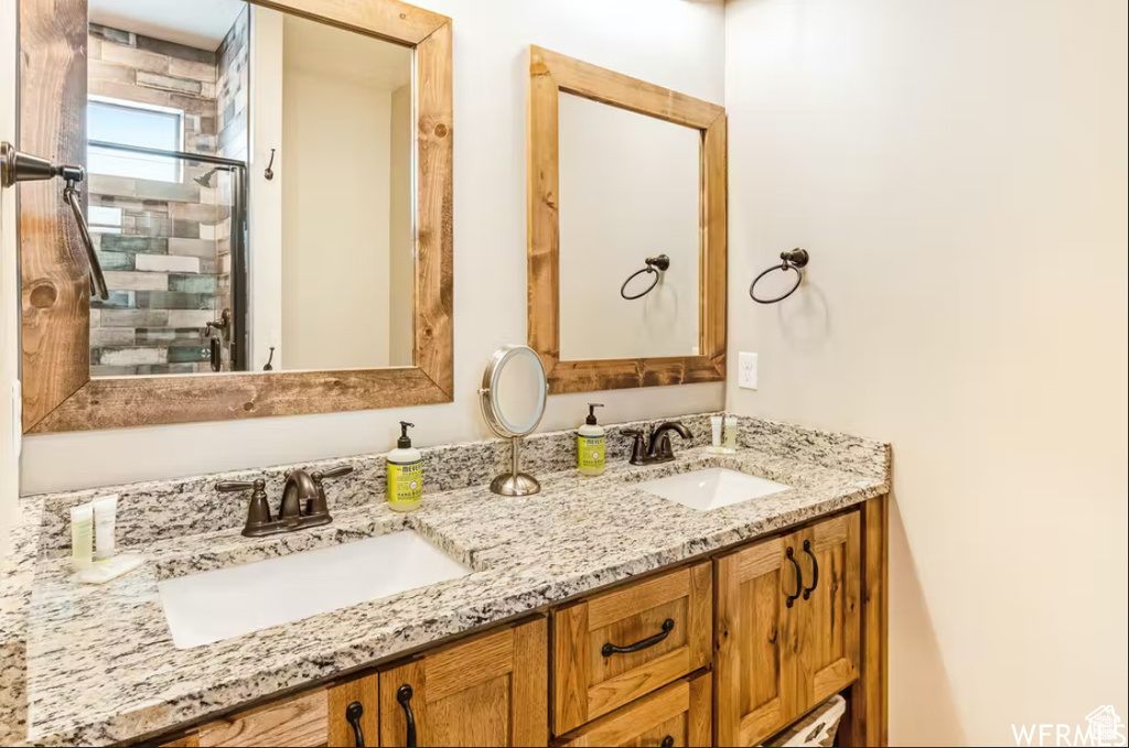 Full bathroom featuring double vanity and a sink