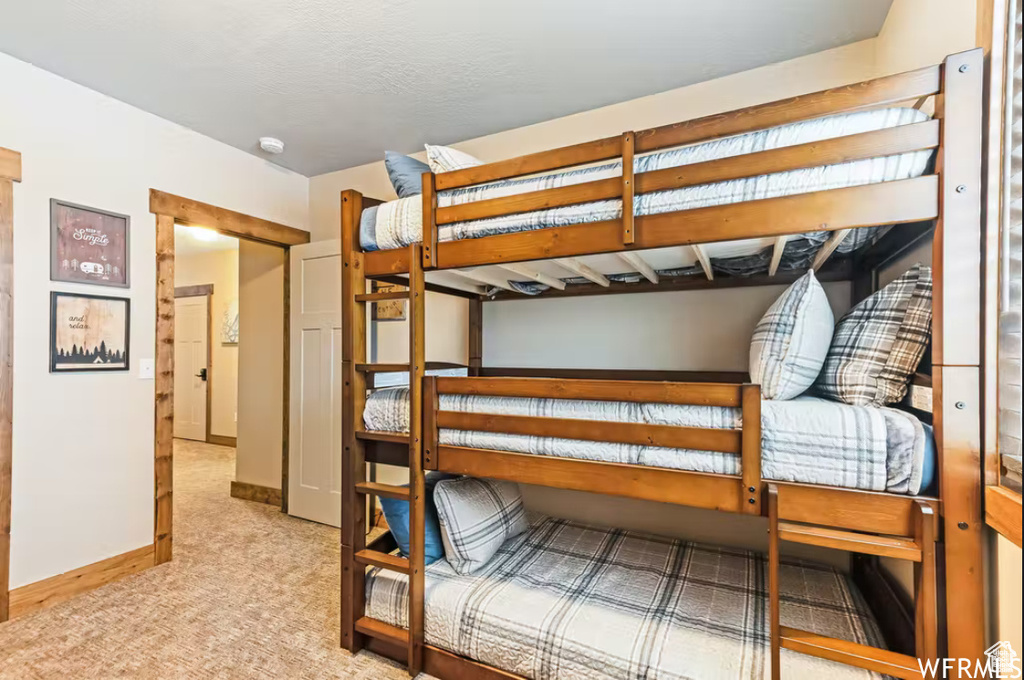 Bedroom with carpet floors and baseboards