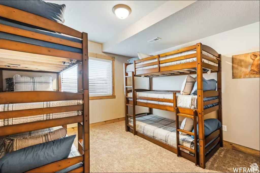Bedroom featuring baseboards, carpet, and visible vents