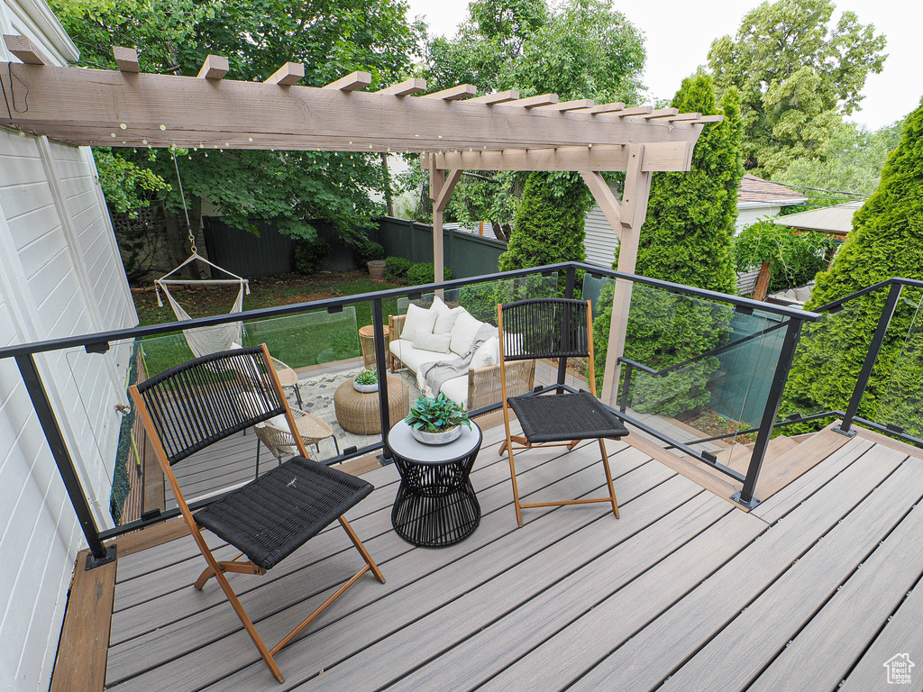 Deck with an outdoor living space and a pergola