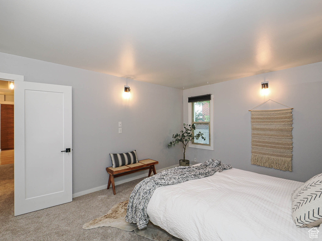 Carpeted bedroom featuring baseboards
