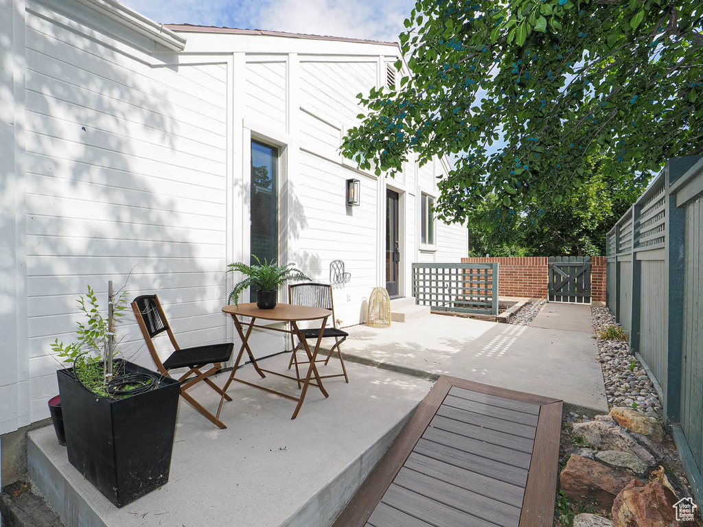 Fenced backyard with a patio and a gate