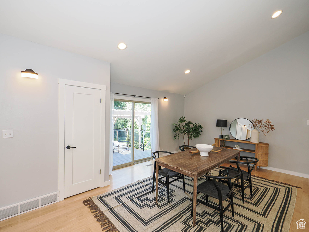 Dining area featuring light wood finished floors, recessed lighting, and lofted ceiling