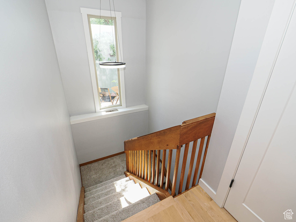 Stairs with baseboards and wood finished floors
