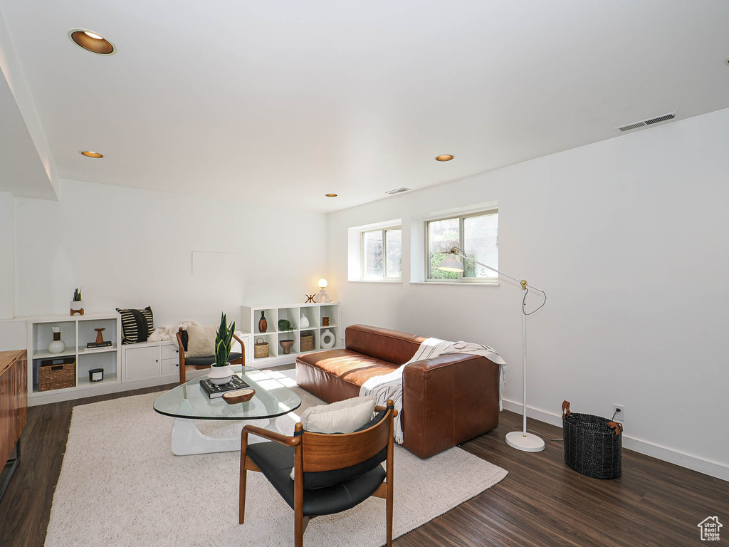 Living room with dark wood-style floors and recessed lighting