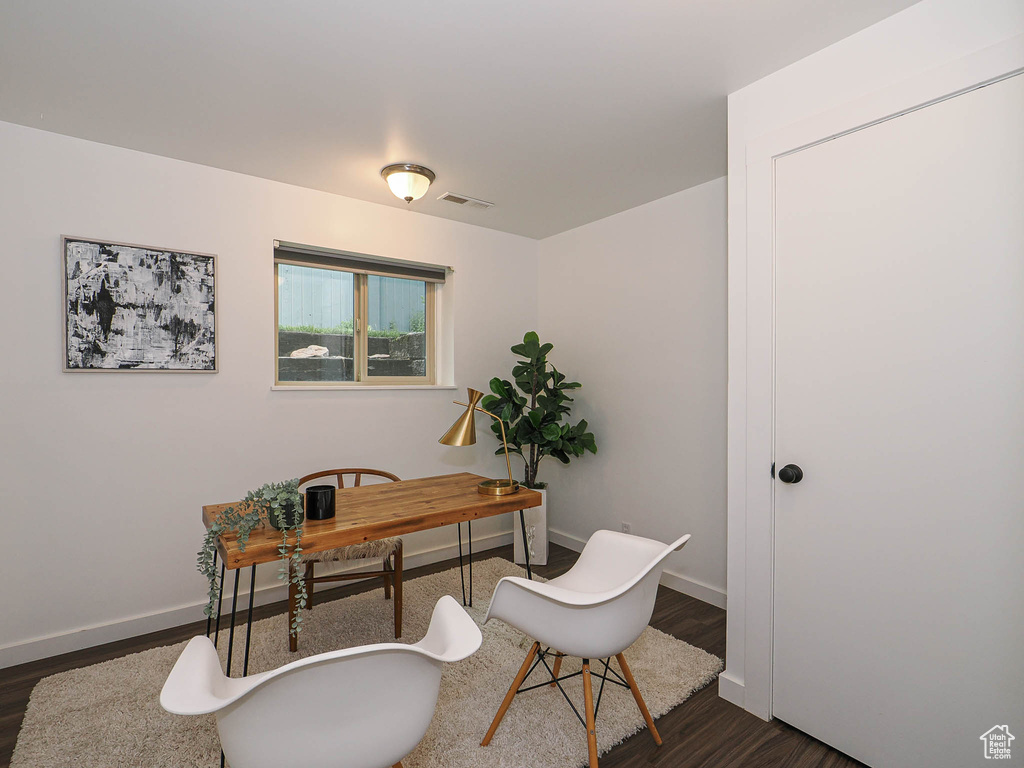Office with dark wood finished floors and baseboards