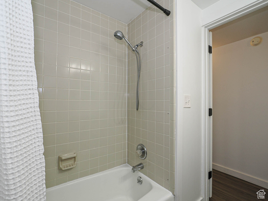 Bathroom with shower / tub combo and wood finished floors