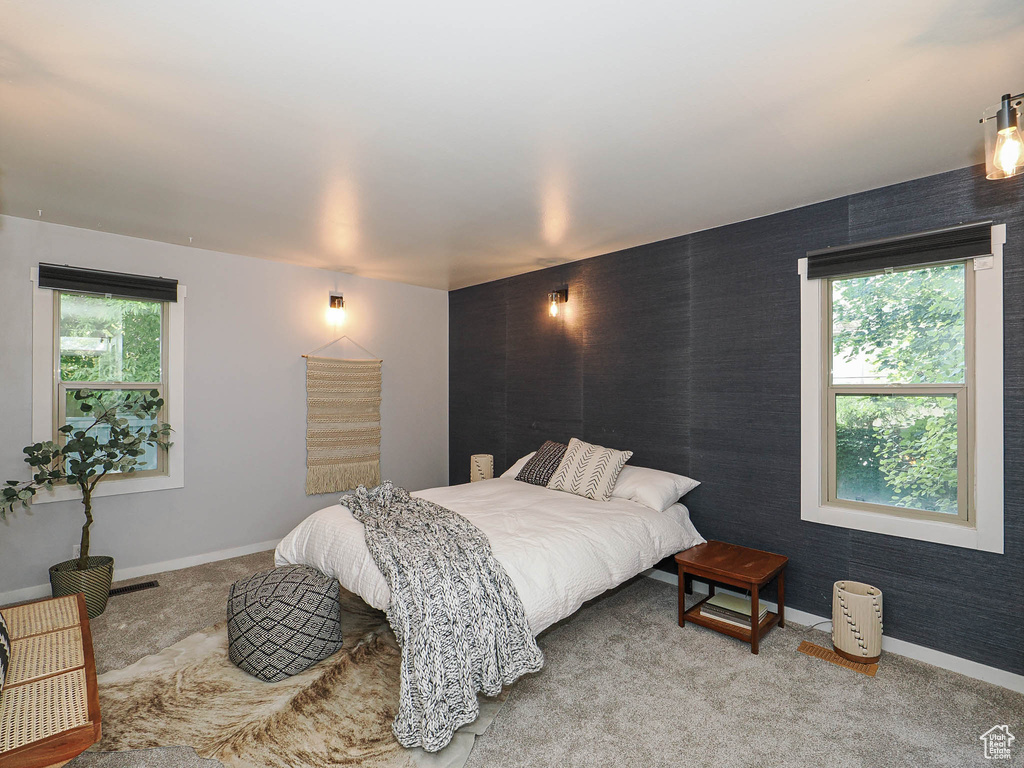 Bedroom featuring carpet flooring and baseboards