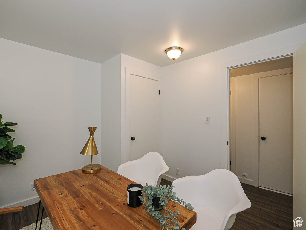 Office space featuring dark wood finished floors and baseboards