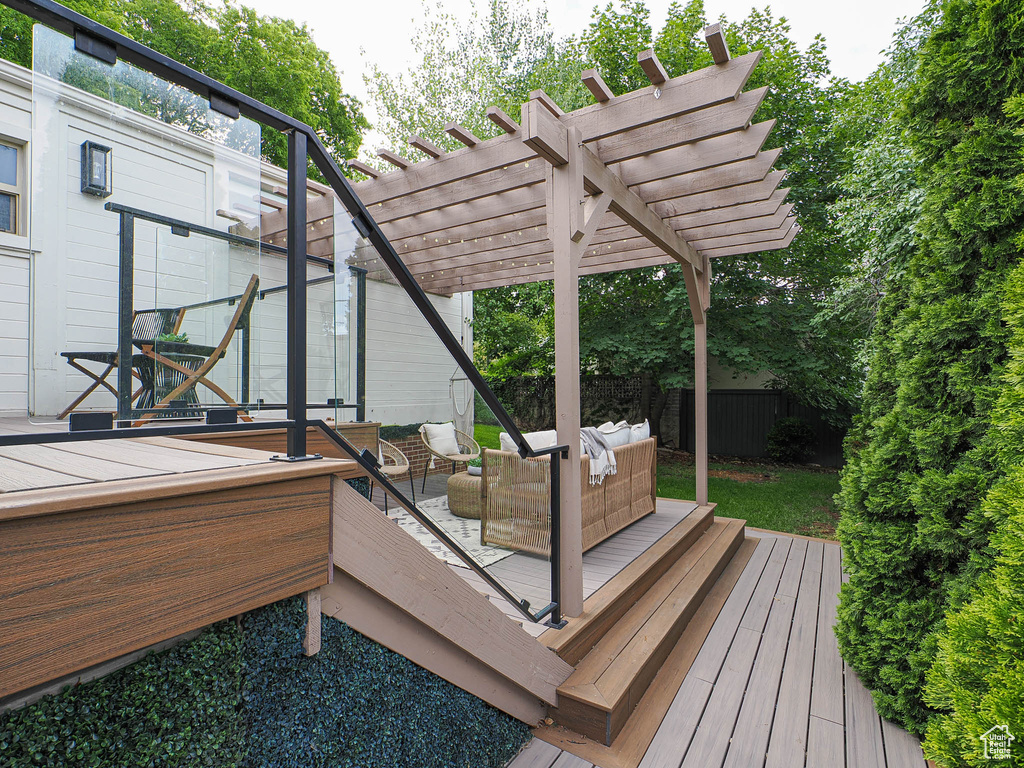 Deck featuring an outdoor hangout area and a pergola