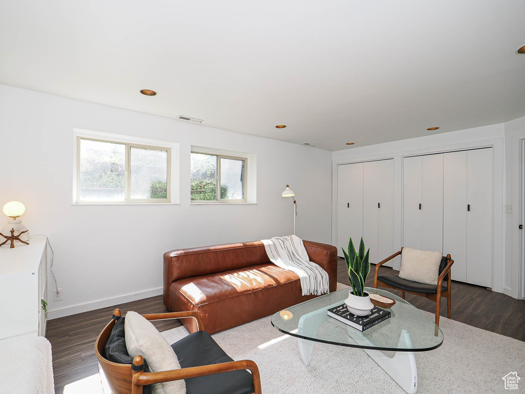 Living room featuring dark wood-style flooring and baseboards