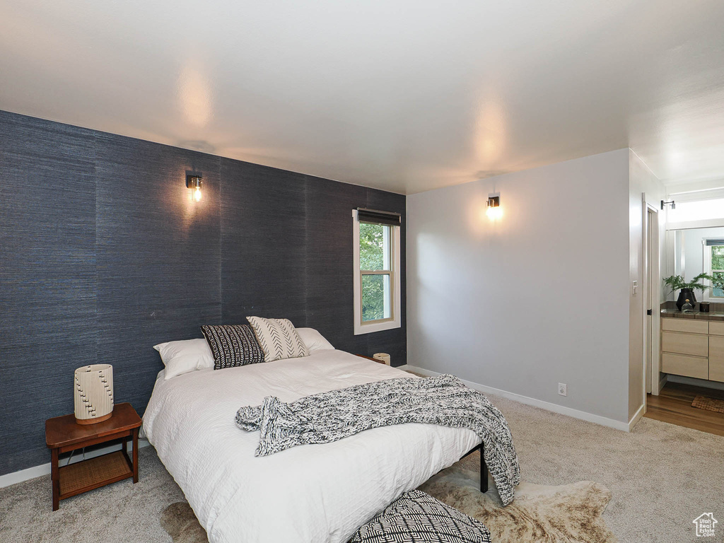 Bedroom featuring baseboards and carpet floors