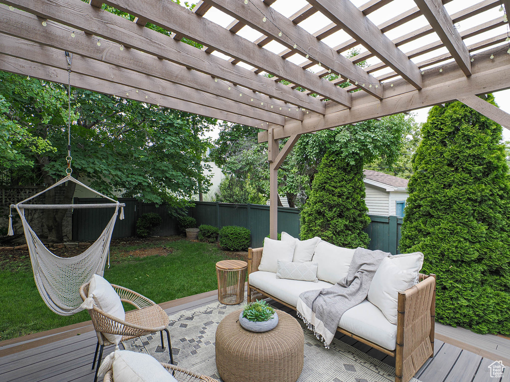 Deck with a fenced backyard and an outdoor hangout area