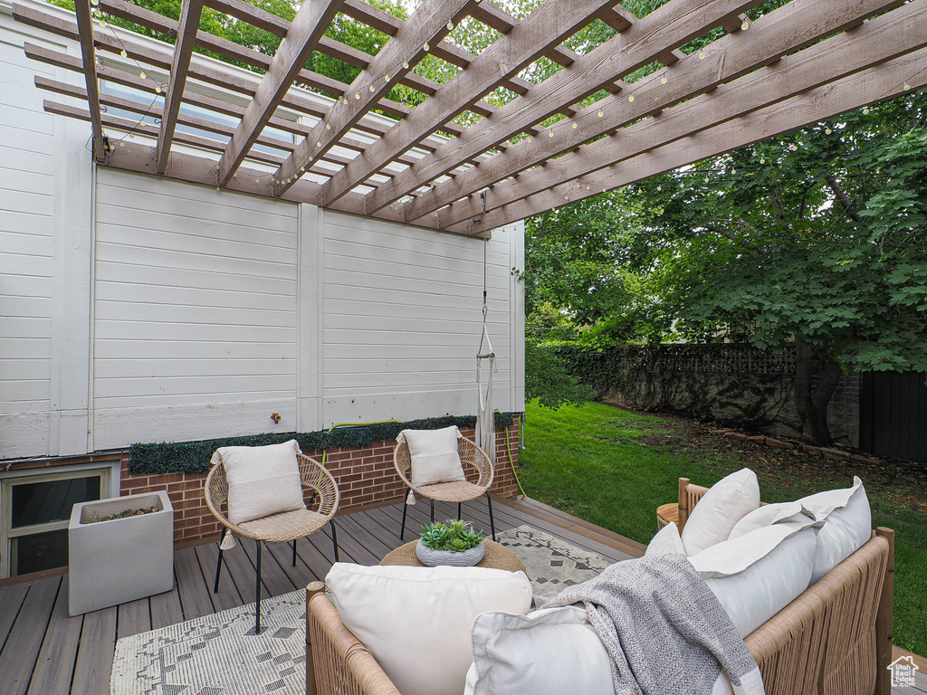 Wooden deck with an outdoor living space and a pergola