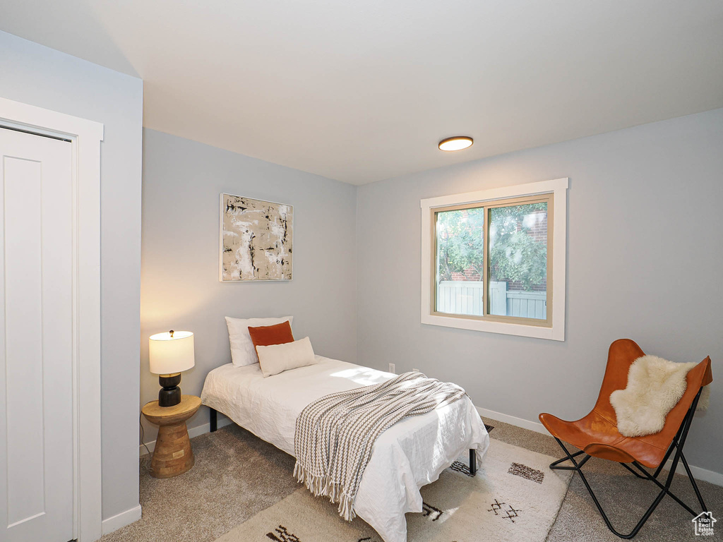 Bedroom featuring carpet floors and baseboards