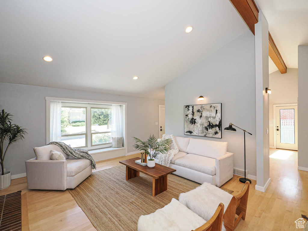 Living area featuring light wood-style floors and recessed lighting