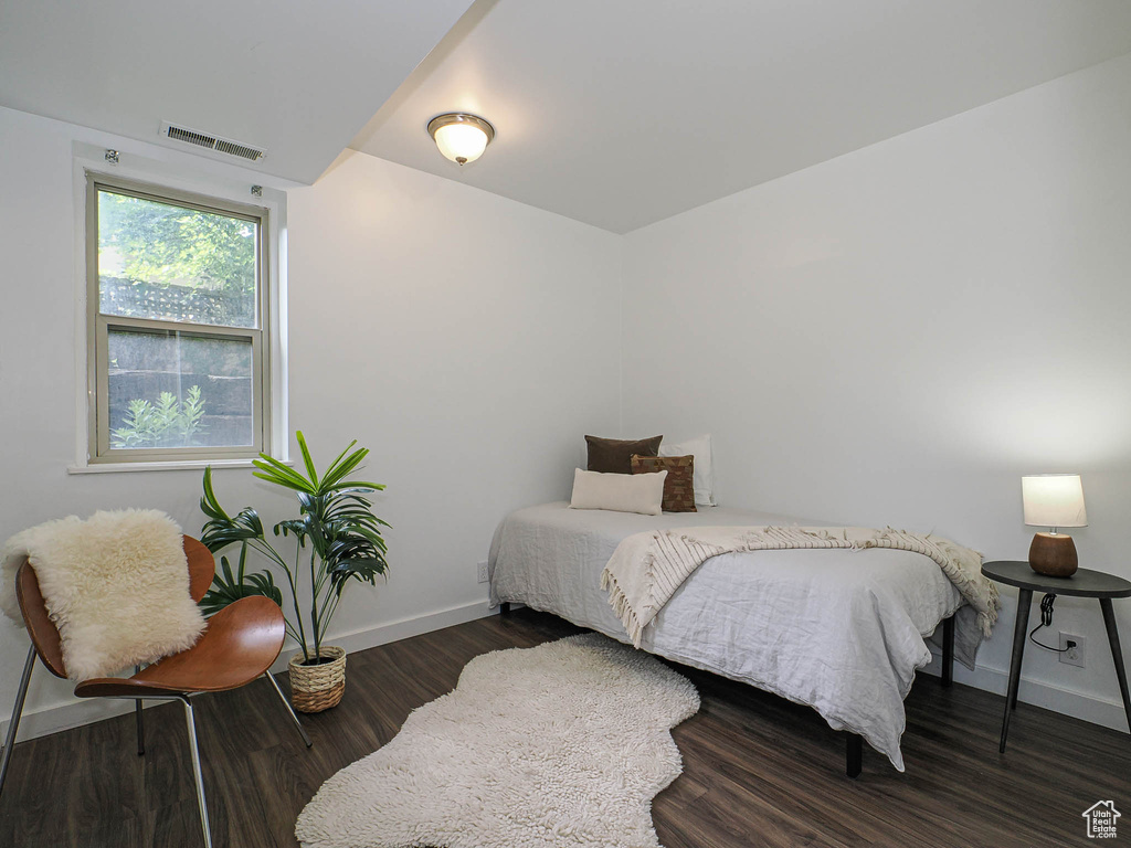 Bedroom featuring baseboards and wood finished floors