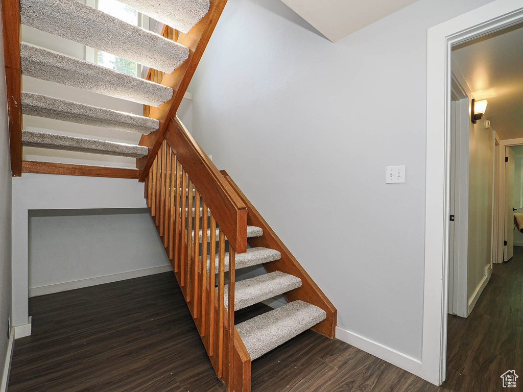 Stairs featuring wood finished floors and baseboards