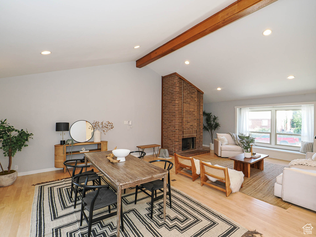Dining room featuring light wood finished floors, a fireplace, and recessed lighting