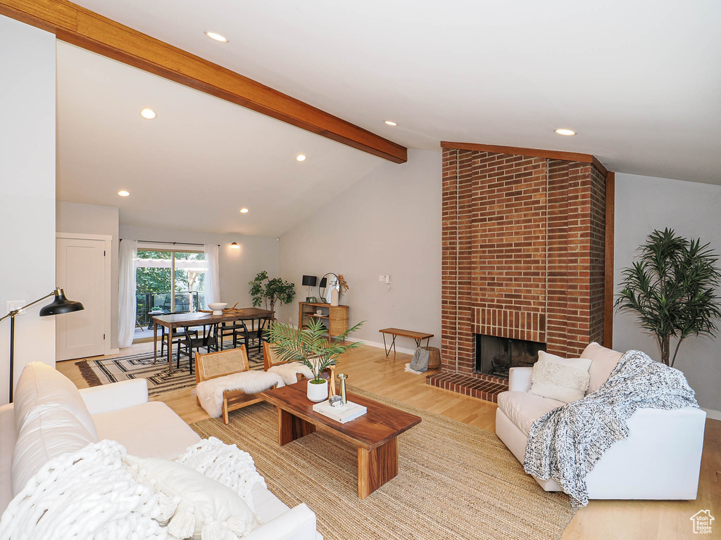 Living area with light wood-style flooring, recessed lighting, and a fireplace