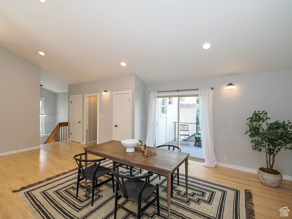 Dining room with light wood finished floors and recessed lighting