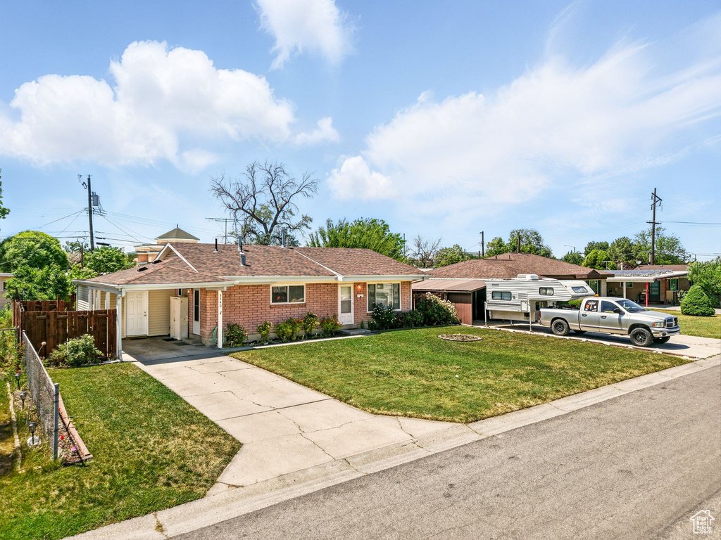 Ranch-style house with concrete driveway, a carport, and brick siding
