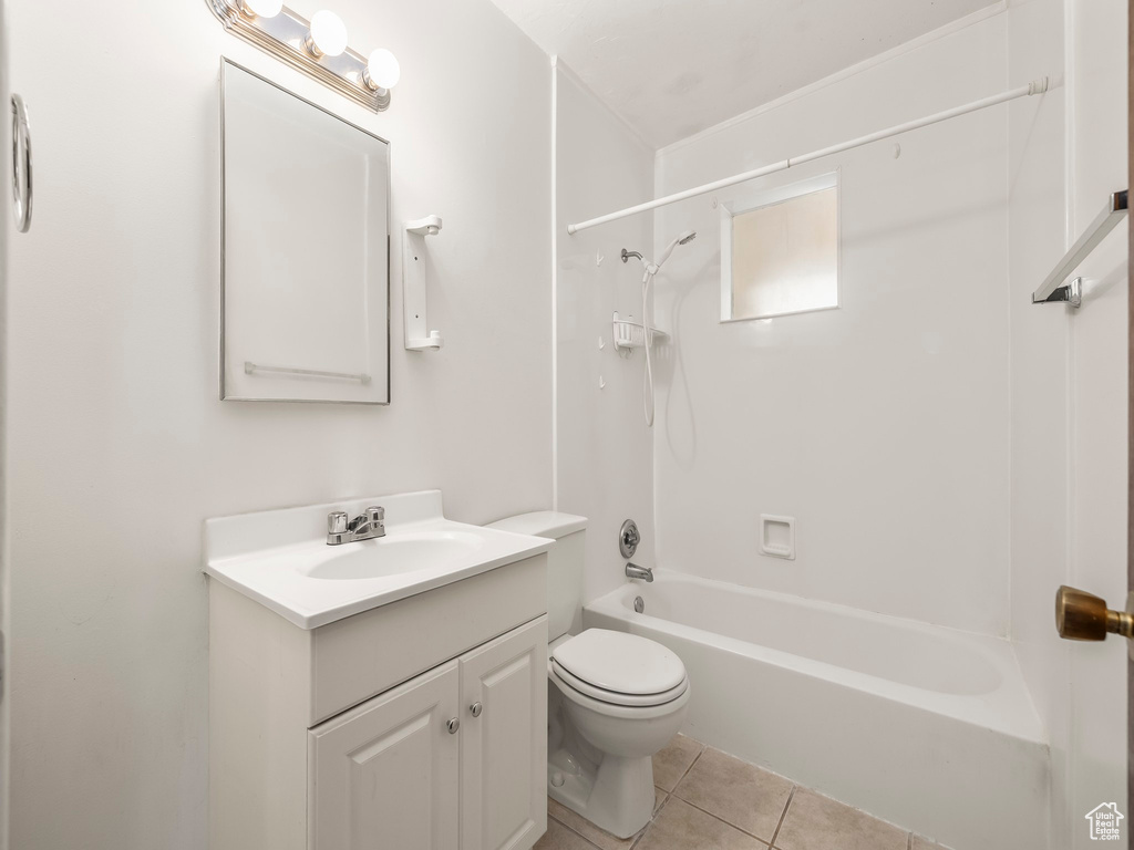 Full bath featuring vanity, tile patterned flooring, and  shower combination