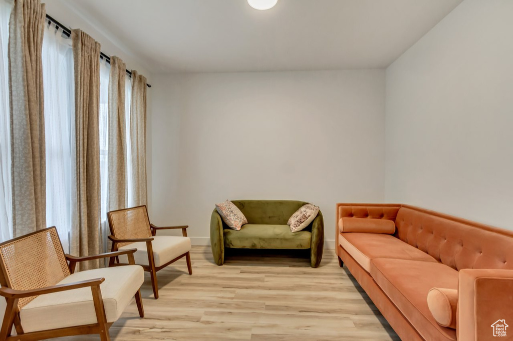 Sitting room featuring light wood finished floors and plenty of natural light