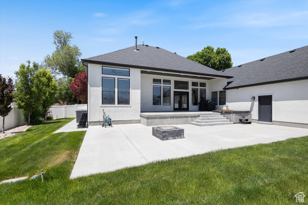 Back of house featuring an outdoor fire pit, a patio, stucco siding, and roof with shingles