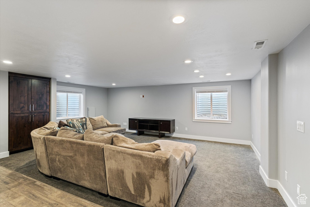Living area with healthy amount of natural light, recessed lighting, and carpet floors