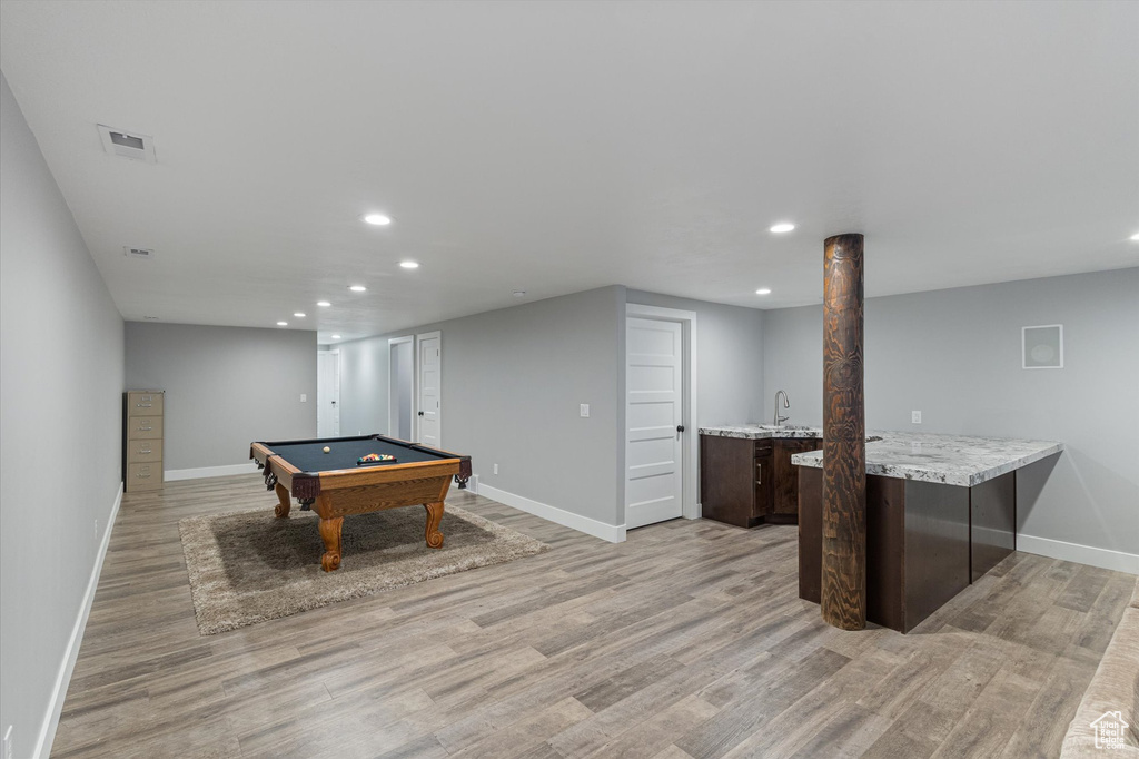 Playroom featuring recessed lighting, billiards table, light wood-style flooring, and bar
