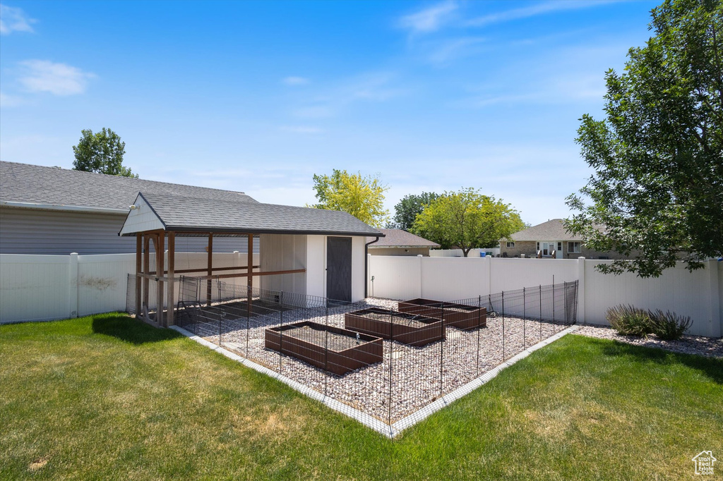 Fenced backyard featuring a garden
