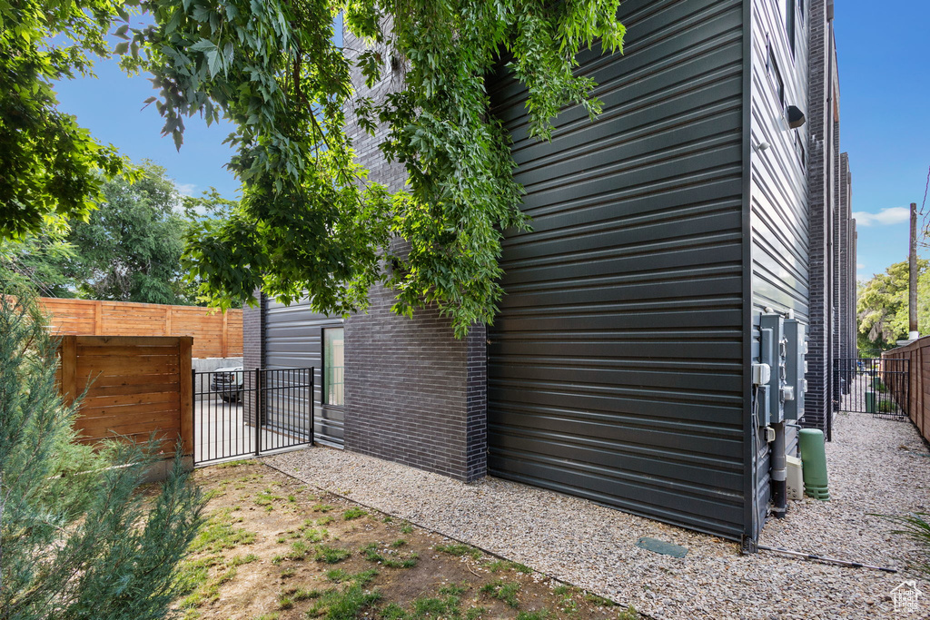 View of property exterior featuring a gate