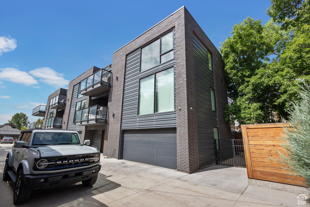 View of front of home featuring an attached garage and concrete driveway
