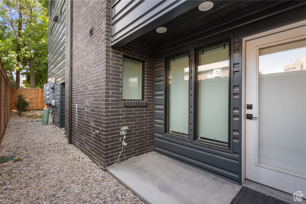 Entrance to property featuring brick siding