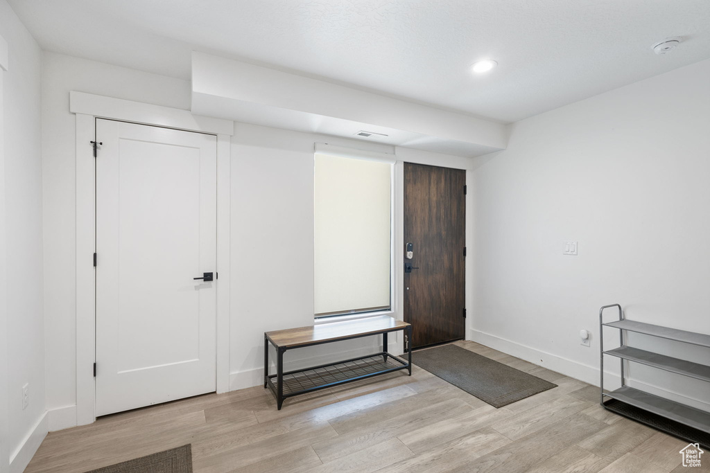 Entryway with light wood-type flooring and recessed lighting