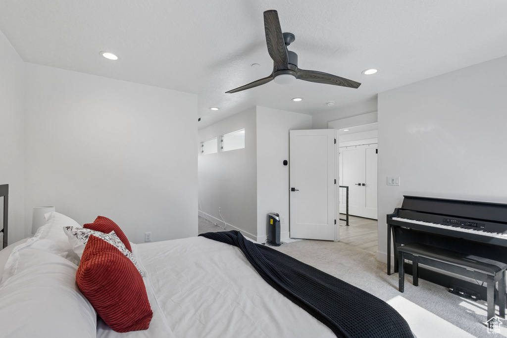 Carpeted bedroom featuring recessed lighting and ceiling fan