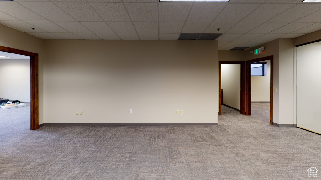 Carpeted spare room with a paneled ceiling