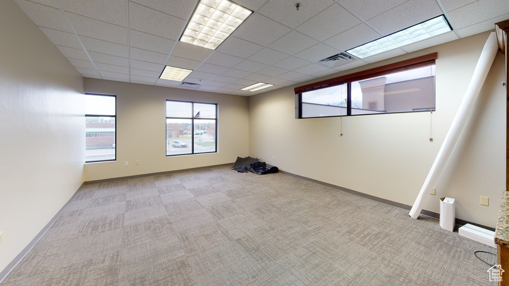 Unfurnished room featuring carpet flooring and a drop ceiling