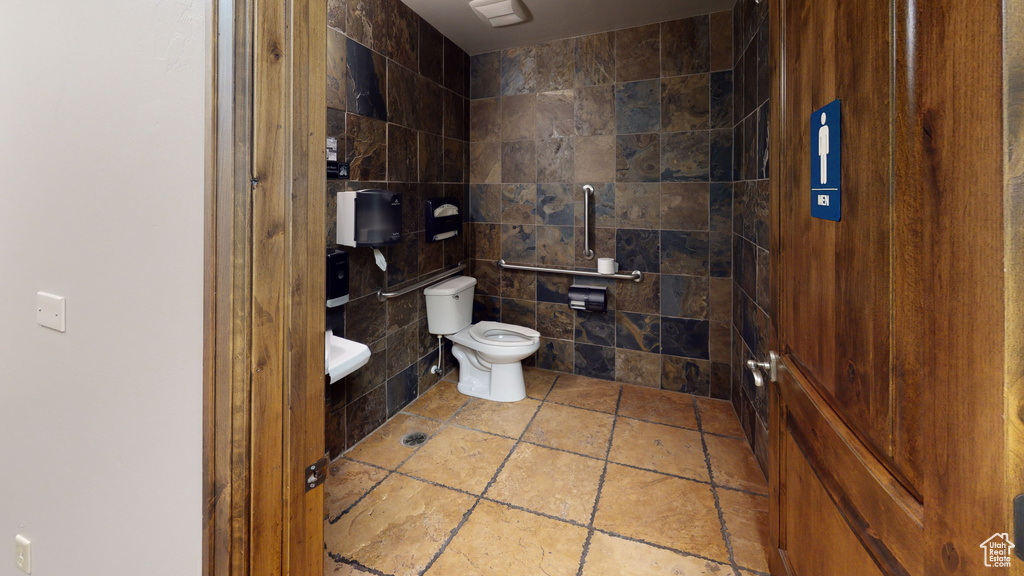Bathroom with tile walls and toilet