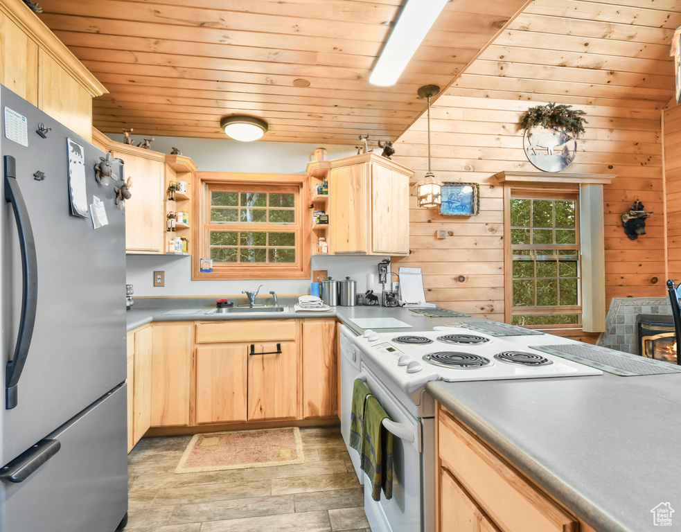Kitchen with white appliances, light brown cabinetry, open shelves, light wood-style flooring, and wooden ceiling