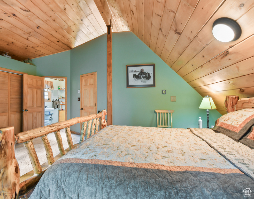 Bedroom with lofted ceiling, wooden ceiling, and carpet floors