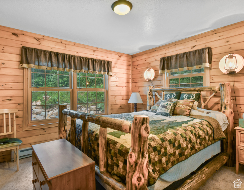 Bedroom with carpet and wood walls