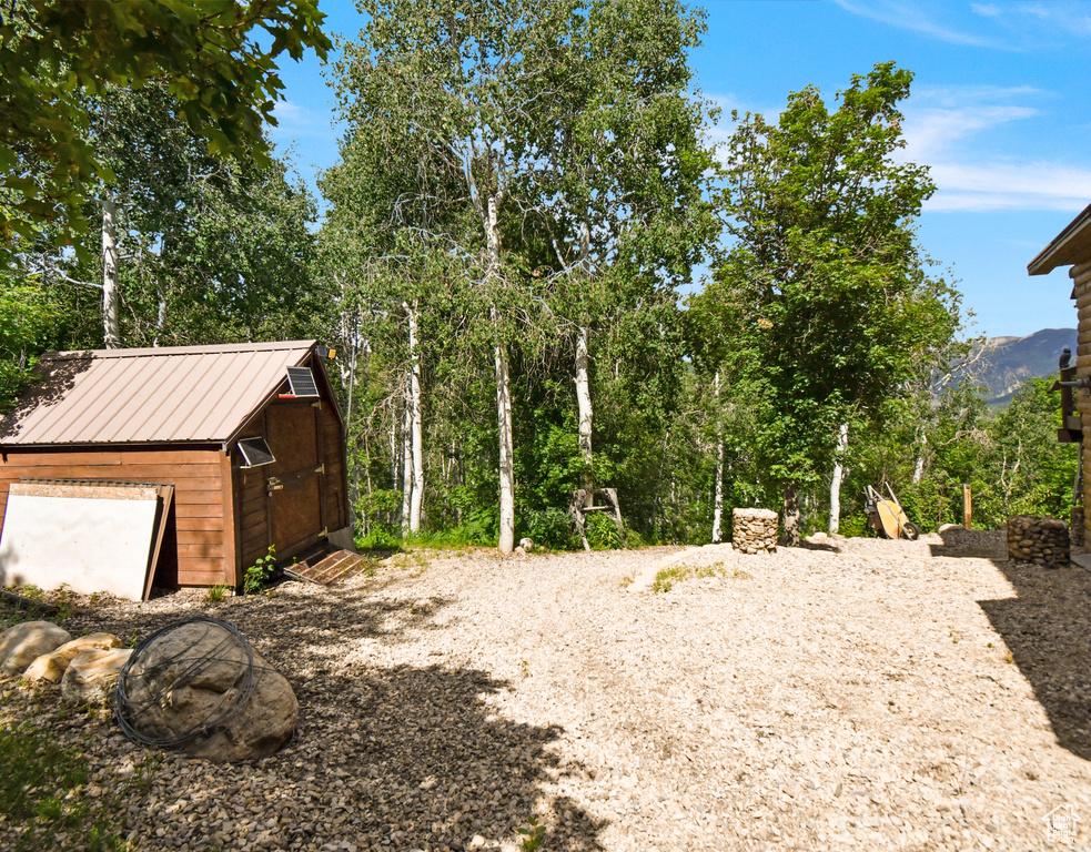 View of yard with a storage unit